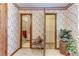 Floral wallpapered hallway with access to bathroom and closet showcases a charming transition space with unique character at 1546 Stormway Ct, Apopka, FL 32712