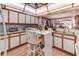 Eat-in kitchen with white cabinets, peninsula countertop, wood trim, open to dining area at 1546 Stormway Ct, Apopka, FL 32712