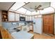 Well-lit kitchen featuring wood-trimmed cabinets, neutral countertops, updated appliances, and wood flooring at 1546 Stormway Ct, Apopka, FL 32712