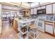 Bright kitchen with a breakfast bar, white cabinets, gray backsplash, and a view into the dining area at 1546 Stormway Ct, Apopka, FL 32712
