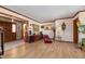 Bright, spacious living area with wood flooring, wood trim, and comfortable seating at 1546 Stormway Ct, Apopka, FL 32712