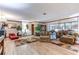 Expansive living room featuring stylish furniture, laminate flooring, and abundant natural light creating a warm, welcoming ambiance at 1546 Stormway Ct, Apopka, FL 32712