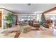 Bright living room with laminate floors, comfortable seating, and large windows creating a relaxing and inviting space at 1546 Stormway Ct, Apopka, FL 32712