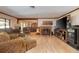 Comfortable living room featuring a fireplace, plush seating, and open access to the dining room at 1546 Stormway Ct, Apopka, FL 32712