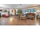 Spacious living area featuring wood flooring, comfortable seating, and natural light at 1546 Stormway Ct, Apopka, FL 32712