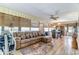 Relaxing sun room with a leather sofa, animal print rug, and ceiling fan at 1546 Stormway Ct, Apopka, FL 32712
