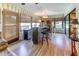 Charming sunroom featuring a built-in bar area, wood-look floors, and light filtering window shades at 1546 Stormway Ct, Apopka, FL 32712