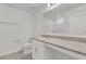 Bright bathroom featuring granite counters, vanity, and a toilet at 3409 Narrows Dr, Lakeland, FL 33810