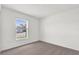 Bright bedroom with neutral carpet and a large window with blinds overlooking the street at 3409 Narrows Dr, Lakeland, FL 33810