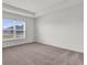 Comfortable bedroom with neutral carpet, a large window with blinds, and ample natural light at 3409 Narrows Dr, Lakeland, FL 33810
