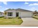 Charming one story home featuring a two car garage, a simple and well manicured front yard, and neutral paint at 3409 Narrows Dr, Lakeland, FL 33810