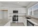 Bright kitchen with stainless steel appliances, granite countertops, white cabinets, and modern fixtures at 3409 Narrows Dr, Lakeland, FL 33810