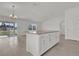 Kitchen island featuring granite countertops, white cabinetry, and an open floorplan design with natural light at 3409 Narrows Dr, Lakeland, FL 33810
