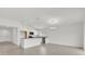 Bright, open-concept kitchen featuring white cabinets, stainless steel appliances, and a granite breakfast bar at 3409 Narrows Dr, Lakeland, FL 33810