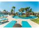 Resort-style pool area with lush landscaping, lounge chairs, and inviting blue waters at 2428 Dubai St, Kissimmee, FL 34747