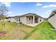 Backyard with a patio, green grass, and modern exterior view of the home at 8560 Caribbean Pine Way, Lakeland, FL 33809