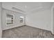 Bright primary bedroom with two windows and a tray ceiling at 8560 Caribbean Pine Way, Lakeland, FL 33809
