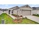Charming one-story home with a two-car garage and beautiful landscaping at 8560 Caribbean Pine Way, Lakeland, FL 33809