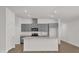 Modern kitchen featuring stainless steel appliances, grey cabinets, and a white countertop island at 8560 Caribbean Pine Way, Lakeland, FL 33809