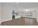 Spacious living area featuring an open floor plan with a modern kitchen and dining area at 8560 Caribbean Pine Way, Lakeland, FL 33809