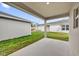Covered patio overlooking a well-maintained backyard and neighboring properties at 8560 Caribbean Pine Way, Lakeland, FL 33809