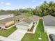 Aerial view of a well maintained home with green lawns and mature landscaping at 8645 Caribbean Pine Way, Lakeland, FL 33809
