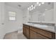 Bathroom featuring double vanity with granite countertops and tile flooring at 8645 Caribbean Pine Way, Lakeland, FL 33809