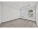 A bedroom featuring neutral carpet, recessed lighting, and two windows at 8645 Caribbean Pine Way, Lakeland, FL 33809