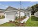 Charming single-story home featuring a two-car garage and a well-manicured lawn and landscaping at 8645 Caribbean Pine Way, Lakeland, FL 33809