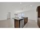 Spacious kitchen featuring stainless dishwasher, granite countertops and dark wood cabinets at 8645 Caribbean Pine Way, Lakeland, FL 33809