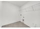 Laundry room with tile floor and wall mounted wire shelving unit at 8645 Caribbean Pine Way, Lakeland, FL 33809