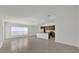 Open living area with kitchen featuring granite countertops and stainless appliances, and large windows at 8645 Caribbean Pine Way, Lakeland, FL 33809