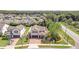 Spacious single Gathering home with lush landscaping and a brick paved driveway, aerial view at 5200 Landmark Dr, St Cloud, FL 34771
