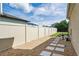 Backyard view featuring a well maintained fence line, minimal landscaping, and gravel ground cover at 5200 Landmark Dr, St Cloud, FL 34771