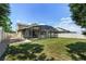 An inviting backyard featuring a screened-in pool and well-maintained lawn perfect for outdoor enjoyment at 5200 Landmark Dr, St Cloud, FL 34771