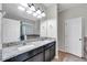 Bathroom featuring double sinks, granite countertop, and tile flooring at 5200 Landmark Dr, St Cloud, FL 34771
