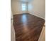 Bright bedroom featuring wood-look flooring, natural light, and neutral paint at 5200 Landmark Dr, St Cloud, FL 34771