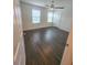 Bedroom boasts wood flooring, a ceiling fan, and access to hallway at 5200 Landmark Dr, Saint Cloud, FL 34771