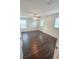 Bedroom with dark floors features ceiling fan and two windows at 5200 Landmark Dr, St Cloud, FL 34771