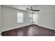 Bedroom features a ceiling fan, two windows, and dark hardwood flooring at 5200 Landmark Dr, St Cloud, FL 34771
