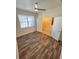 Bright bedroom featuring luxury vinyl plank flooring and neutral paint at 5200 Landmark Dr, St Cloud, FL 34771