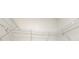 Walk-in closet has metal shelving and bright white walls at 5200 Landmark Dr, St Cloud, FL 34771