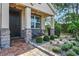 Charming front porch with stone accents, cozy seating, and landscaped garden at 5200 Landmark Dr, St Cloud, FL 34771