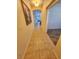 Hallway view showcasing tile flooring and archway to stairs and alternate room at 5200 Landmark Dr, St Cloud, FL 34771