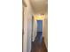 Hallway with wood floors and recessed lights with multiple doors at 5200 Landmark Dr, St Cloud, FL 34771