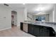 Modern kitchen with granite countertops, stainless steel appliances, and open view to the living area at 5200 Landmark Dr, St Cloud, FL 34771