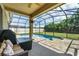Screened-in pool area with patio furniture, grill, and lush green lawn at 5200 Landmark Dr, St Cloud, FL 34771