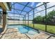 Sparkling swimming pool in screened lanai with beautiful pavers at 5200 Landmark Dr, St Cloud, FL 34771