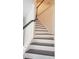 A view of staircase with white and brown steps and white banister at 5200 Landmark Dr, St Cloud, FL 34771