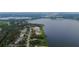 Gorgeous view of neighborhood homes along the water with lush trees and manicured lawns at 16828 Vinci Way, Montverde, FL 34756